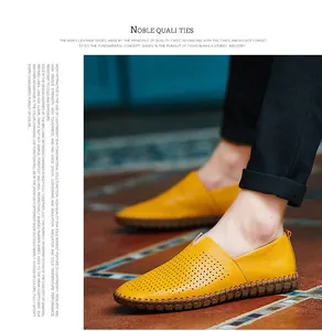 Close-up of yellow perforated genuine leather loafers with hand-stitched detailing