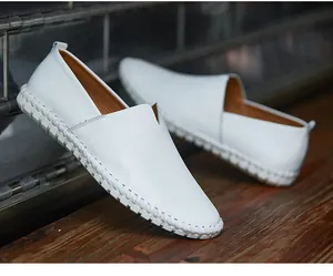 Detailed macro view of white textured leather loafers with thick patterned sole design
