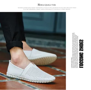 Detailed view of white perforated leather loafers for men with casual slip-on design.