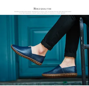 Detail view of navy blue leather slip-on loafers with hand-stitched sole detail