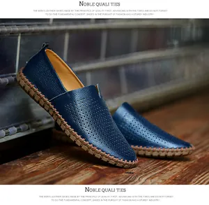 Side view of navy blue perforated leather loafers with distinctive hand-stitched sole