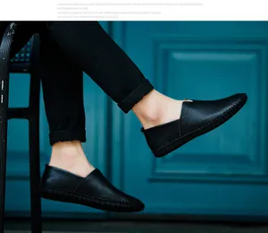 Close-up of men's black leather loafers showing grain texture and slip-on style