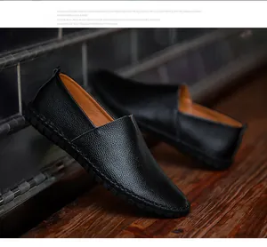 Detail showing texture of black top-grain leather loafers with hand-stitched sole