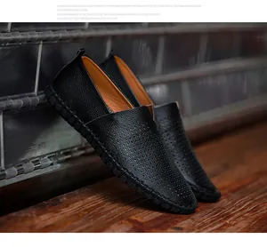 Detail view of black men's slip-on loafers featuring breathable perforated leather
