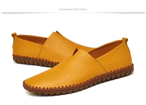 Detail view of yellow top-layer cowhide men's slip-on loafers with hand-stitched soles