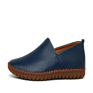 Detailed side view of navy blue genuine leather slip-on comfort loafers for men