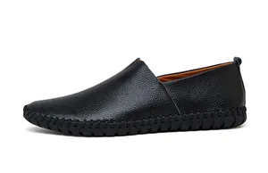 Side view of black textured leather slip-on loafers with unique stitched sole detail.