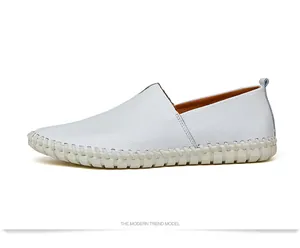 Side view of white cowhide leather loafers with decorative hand-stitching detail.