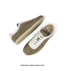Detailed overhead shot of vintage brown suede German Army Trainers with white laces