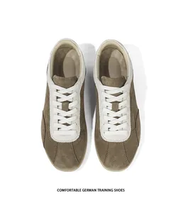 Top-down macro view of brown suede German training shoes with white laces