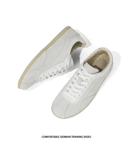 Detailed top view of minimalist off-white suede German Army Trainers with thin gum soles