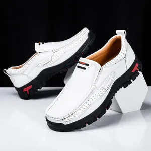 Detailed view of white men's casual loafers with breathable perforations and black soles