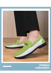 Detailed shot of stylish green and white perforated men's loafers worn by a model