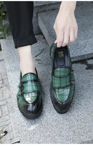 Detailed view of men's green crocodile pattern monk strap loafers with thick soles