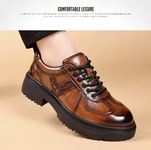 Close-up of brown leather Derby shoes with crocodile pattern and thick sole
