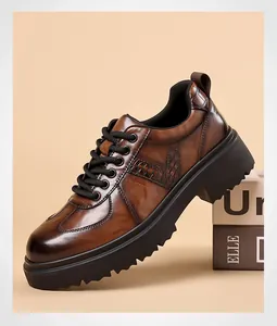 Detail of brown leather derby shoes with crocodile texture and thick platform soles
