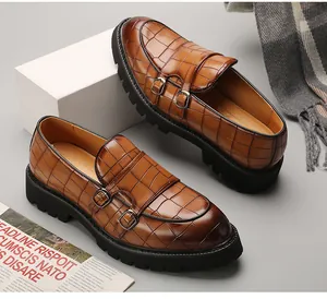 Detailed view of men's brown crocodile patterned monk strap shoes with thick lug soles