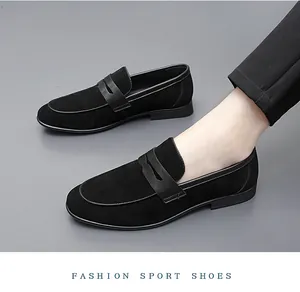 Close-up detail of black suede loafers for men with elegant stitching and business style.