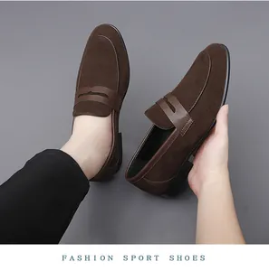 Close-up detail of dark brown suede penny loafers featuring premium leather strap