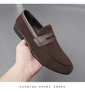 Close-up of men's brown suede loafers with stylish leather strap detail.
