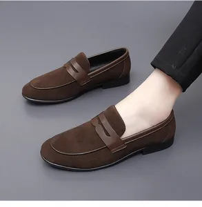 Close-up detail of stylish brown suede loafers for men with a classic slip-on design