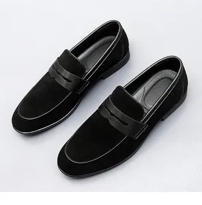 High-angle shot showing a pair of classic black suede men's loafers with sleek leather details.