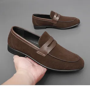 Detail shot of brown suede men's loafers with smooth leather trim