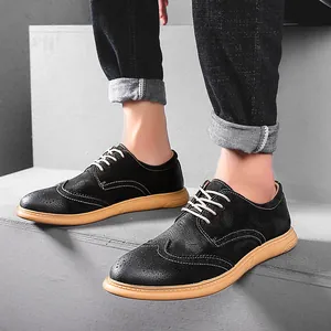 Men's retro British Brogue casual suede shoes with light tan sole on concrete steps