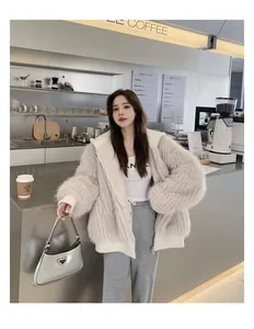 Detailansicht einer gemütlichen beigen Kunstpelzjacke mit Kapuze und Rippbündchen.