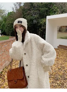 Chic off-white long teddy coat for women with cozy winter knit beanie and brown bag