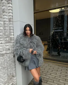 Detailed street style view of a premium fluffy grey faux fur coat for winter parties and events