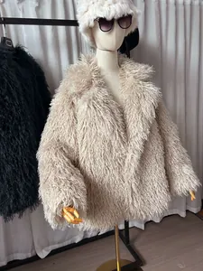 Detail view of a cream shaggy faux fur coat with a lapel collar on a mannequin.