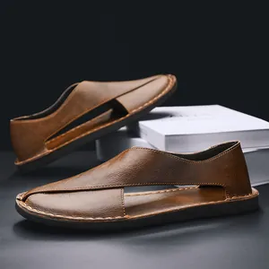 Detail view of handmade retro brown leather sandals with hollow-out design and soft sole