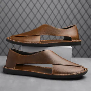 Detailed view of handmade brown leather hollow-out sandals with closed toe design