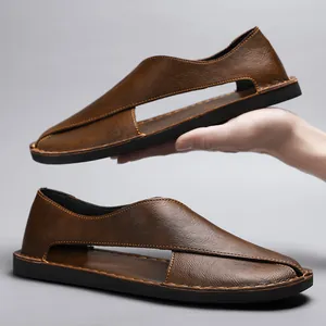 Close-up of brown leather retro hollow-out casual sandals for men with soft sole.