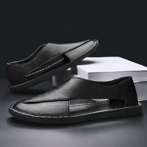 Close-up detail of black leather hollow-out sandals with vintage closed-toe design