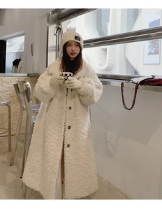 Detailed view of long cream teddy coat featuring soft fleece texture and buttons