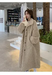 Detail view of a stylish long beige teddy coat with soft texture and button details