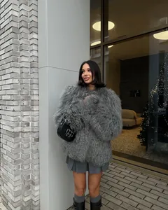 Elegant grey shaggy faux fur coat styled with a pleated skirt and black leather boots.