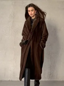 Detailed full-length shot of a woman wearing a luxurious long brown faux fur coat