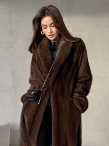 Detailed view of the luxurious long brown faux fur coat with soft texture