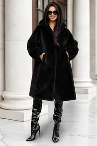 Close-up detail of luxurious long black faux fur coat with hood for women's winter fashion