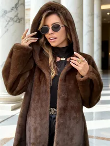 Close-up showing the rich texture of a luxury brown long hooded faux fur winter coat