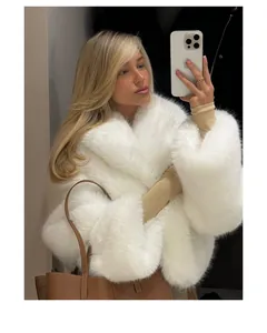 Detailed view of white plush faux fur coat worn by model in mirror selfie
