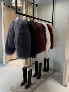 Colorful shaggy faux fur coats hanging in store with designer style tall boots