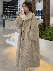 Elegant long beige faux shearling teddy coat for women shown in a cozy cafe setting