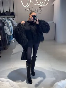 Elegant oversized black shaggy faux fur jacket with fluffy wool texture for winter