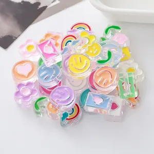 Macro view of colorful drip oil acrylic beads with smiley faces and rainbows for DIY