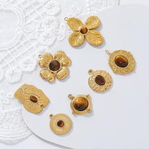 Detail of vintage tiger eye stone pendants with 18K gold plated stainless steel.