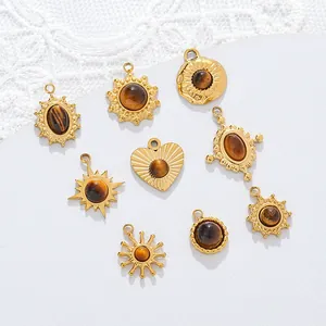 Detailed macro view of 18K gold plated stainless steel tiger eye pendants for DIY jewelry.